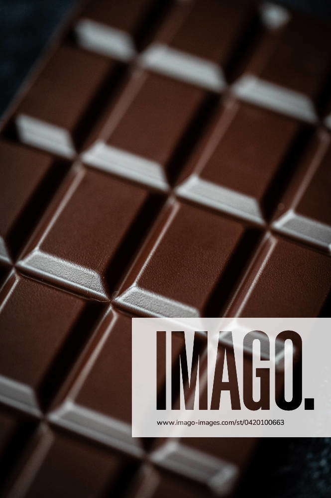Close up macro of squares of a bar of dark chocolate from above