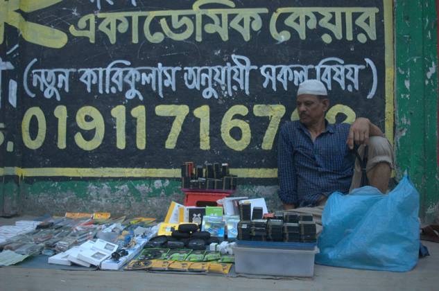 March 14, 2024, Dhaka, Bangladesh: A vendor waits for customers as he ...