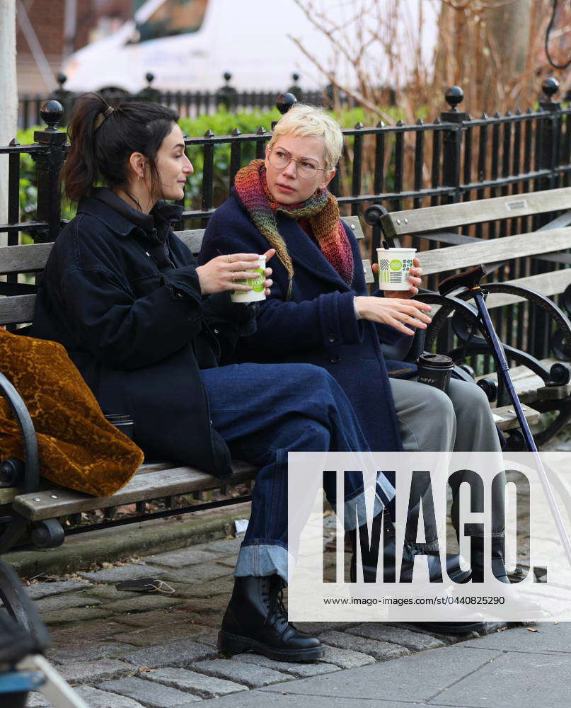 Michelle Williams and Jenny Slate sitting in a park filming on the ˜Dying  for Sex