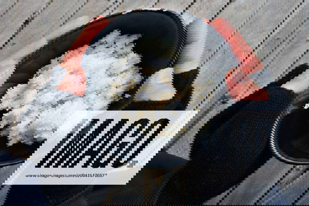 Homeless holding a bowl of rice in community food kitchen PERTH, WA