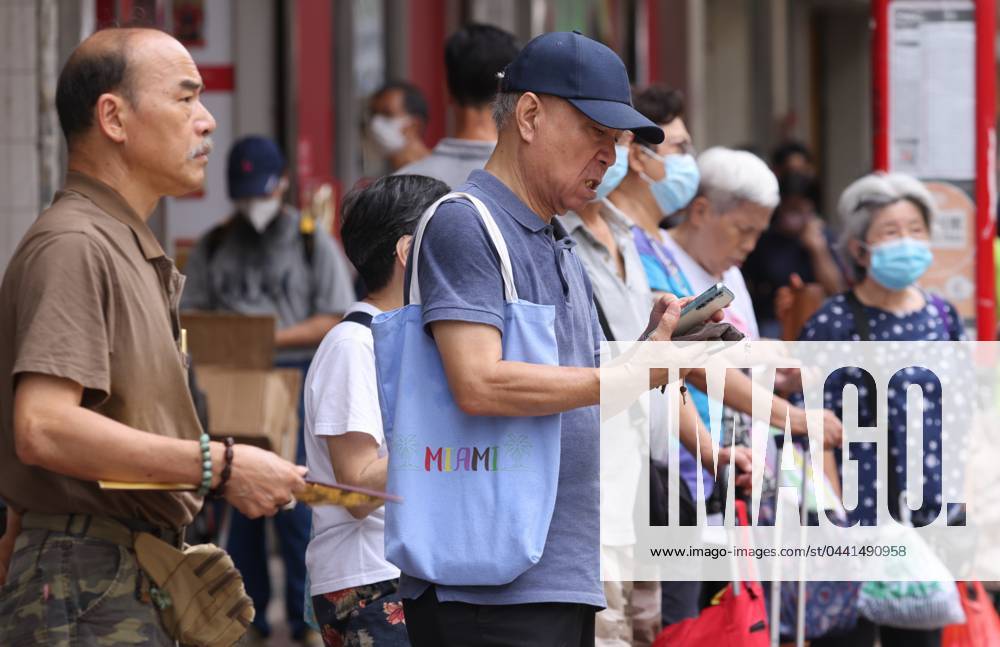 An Elderly Uses His Mobile Phone At A Bus Station In Sham Shui Po 