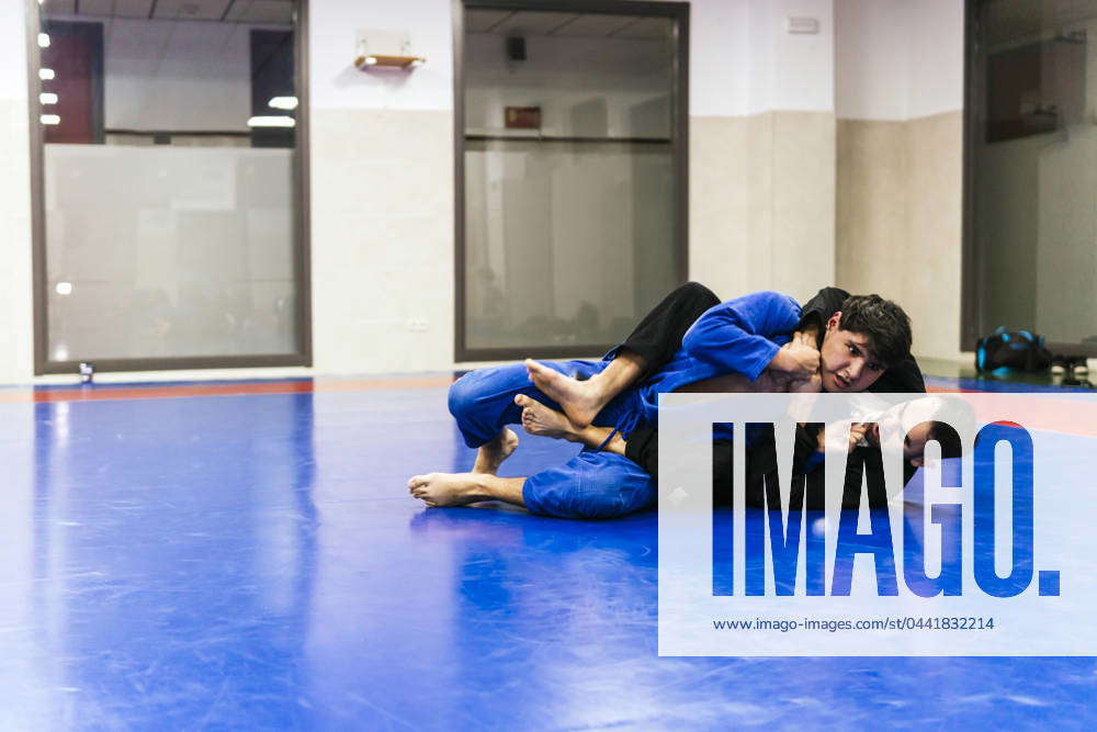 Athletes doing wrestling in jujitsu training at dojo model released ...