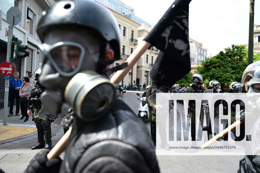 Protesters with gas masks and riot police follows a rally organized by ...