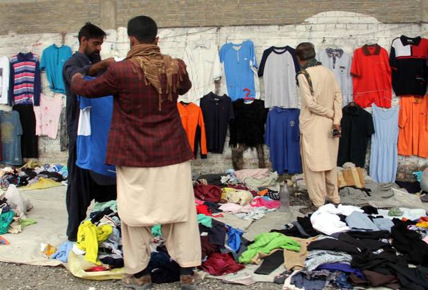 QUETTA, PAKISTAN, MAY 12: People are buying clothes, at a weekly Bazar ...