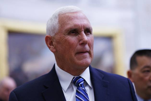 Former US Vice President Mike Pence walks through the Rotunda of the US ...