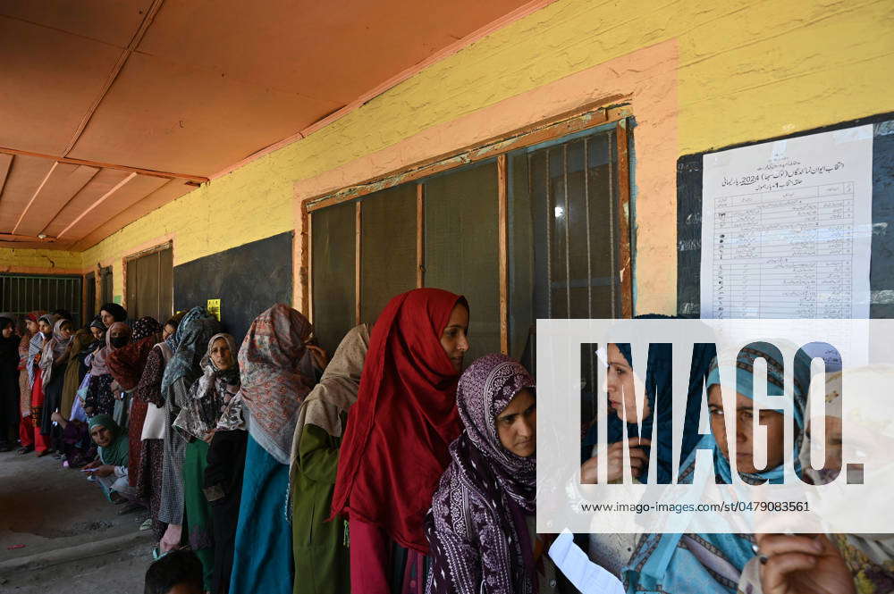 BARAMULLAH, INDIA - MAY 20: People stand in queue to cast their votes ...