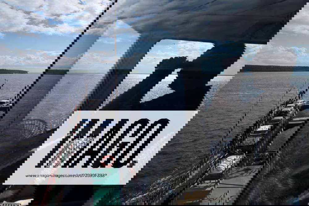 RUSSIA YAMALO NENETS AUTONOMOUS AREA A Man Steers A Ferry Running russia-yamalo-nenets-autonomous-area-a-man-steers-a-ferry-running