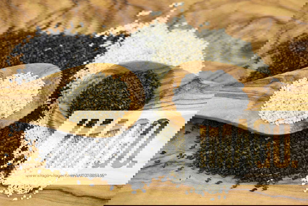 Sesame Sesamum indicum , peeled and unpeeled Sesame seeds with Wooden