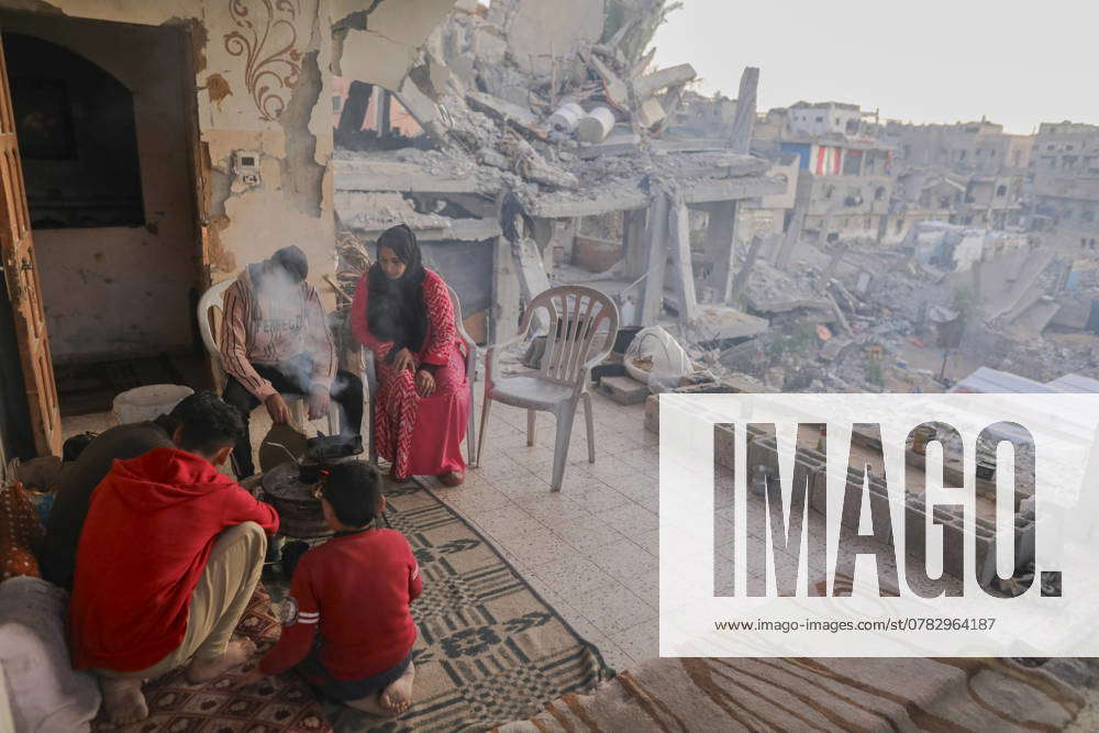 Israeli Palestinian conflict A Palestinian family sits amidst the ...