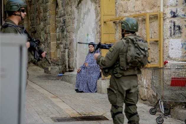 Israeli Palestinian conflict A Palestinian family sits amidst the ...