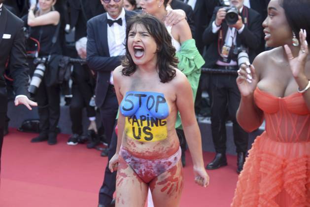a Nude protester With The Ukraining Flag and Stop raping US Painted ON
