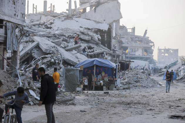 DAILY LIFE IN GAZA People walk through the ruins of destroyed buildings ...