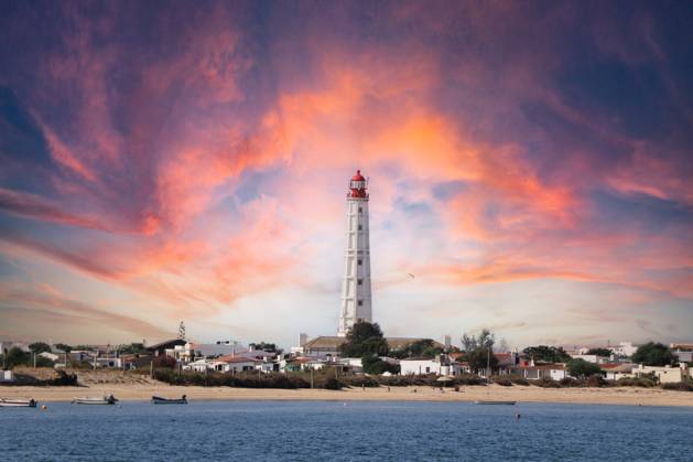 Sunset Beautiful lighthouse at the sunset Olhão, Faro District, Portugal