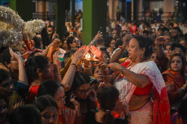 NOIDA, INDIA - SEPTEMBER 30: Devotees light earthen lamps while ...