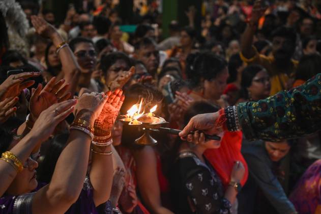 NOIDA, INDIA - SEPTEMBER 30: Devotees light earthen lamps while ...