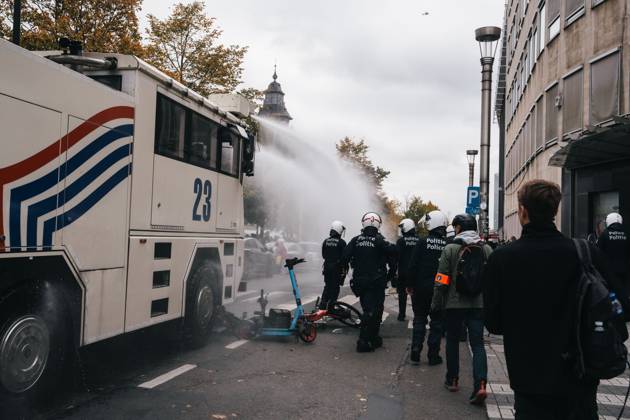 Riot police pictured as the water canon is used at a joint ...