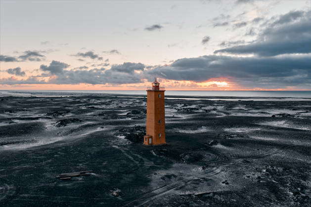 Alviðruhamarviti lighthouse standing on black sand beach in iceland Vik ...