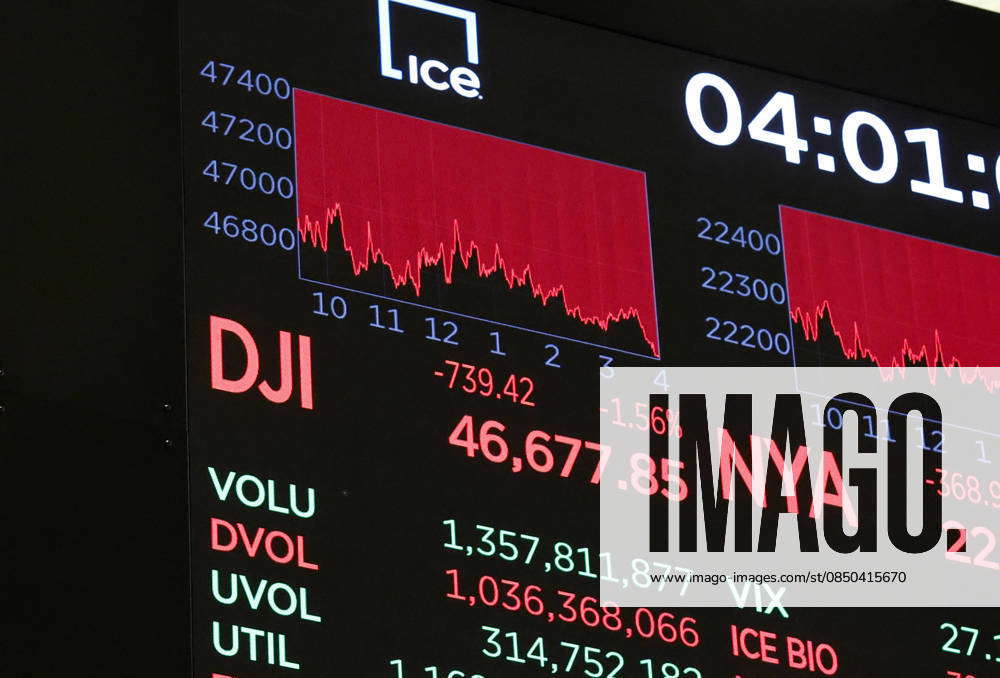 A board on the floor of the NYSE shows the DJIA down over 700 points ...